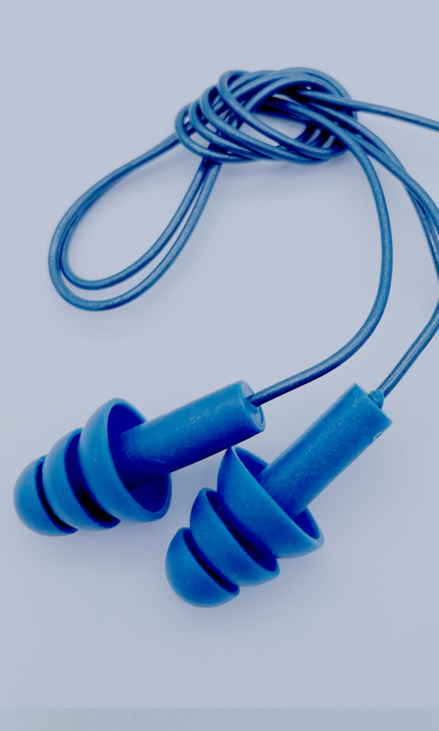 A close-up of a pair of blue detectable earplugs with a triple-flange design.