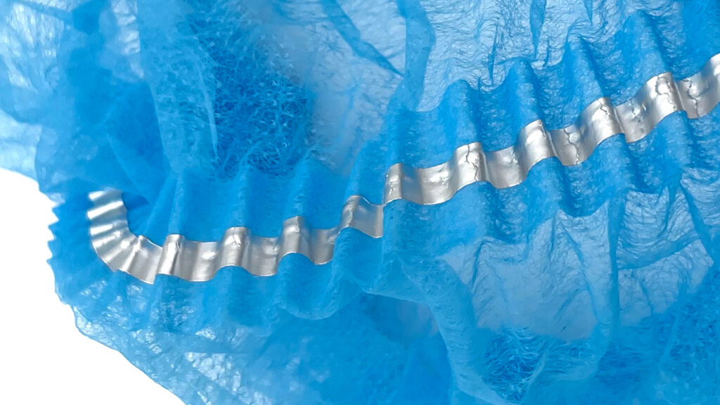 Close-up of a blue detectable hairnet with an integrated metal strip.