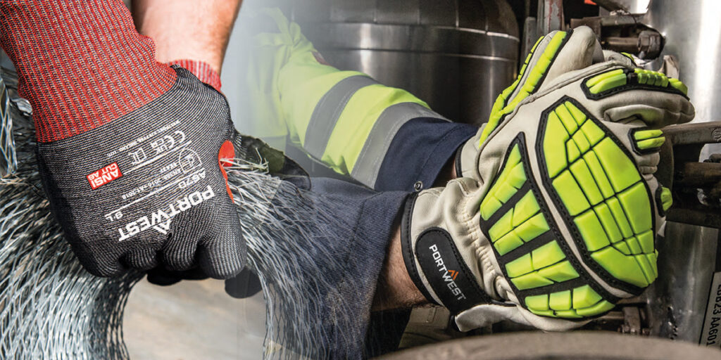 Worker wearing Portwest work gloves while carrying out maintenance work on a machine.