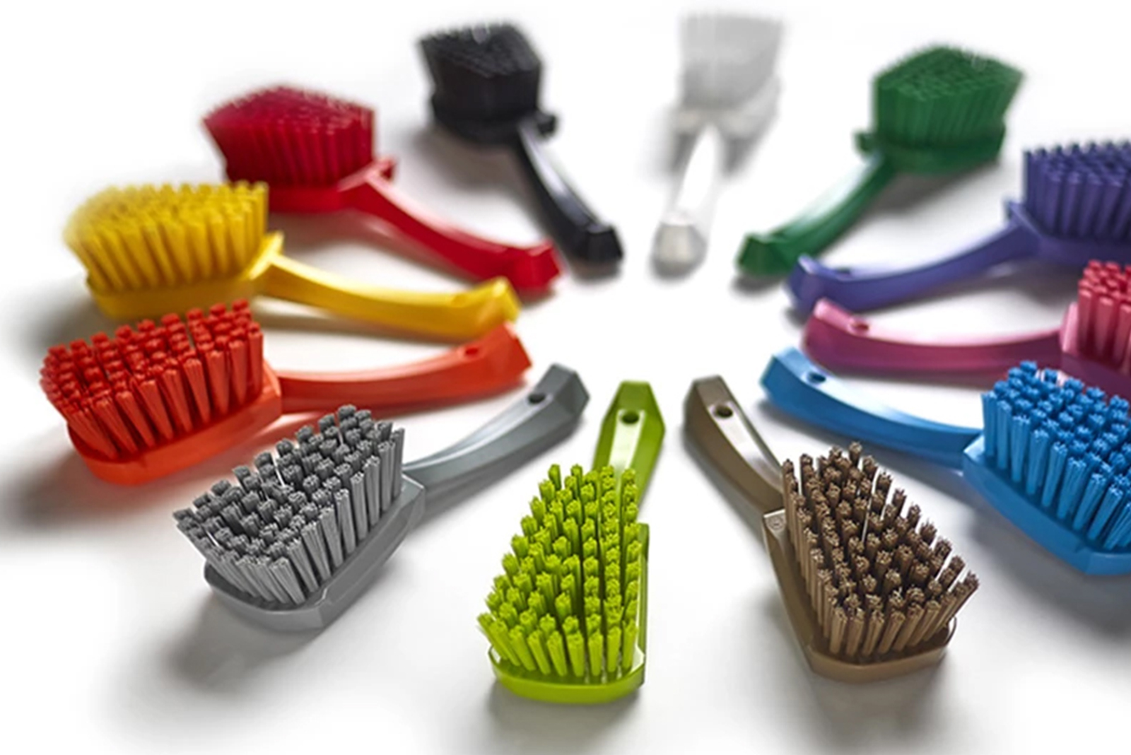 A collection of Vikan brushes in 12 different colours