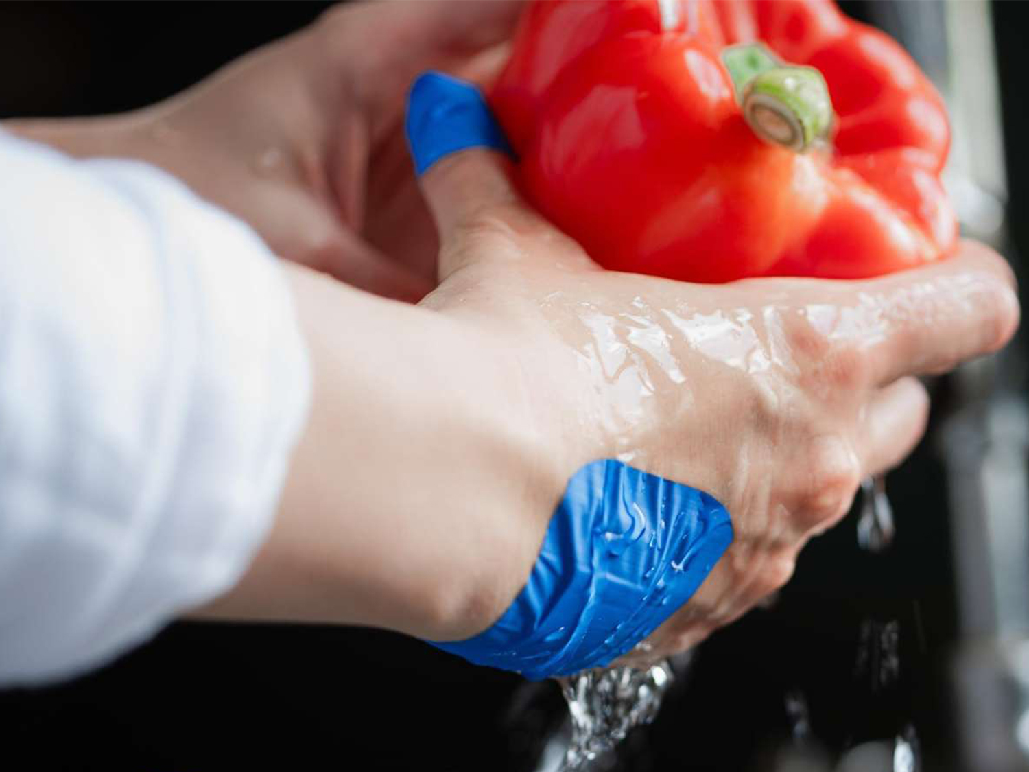 Waterproof plaster while washing a bell pepper in a food processing environment