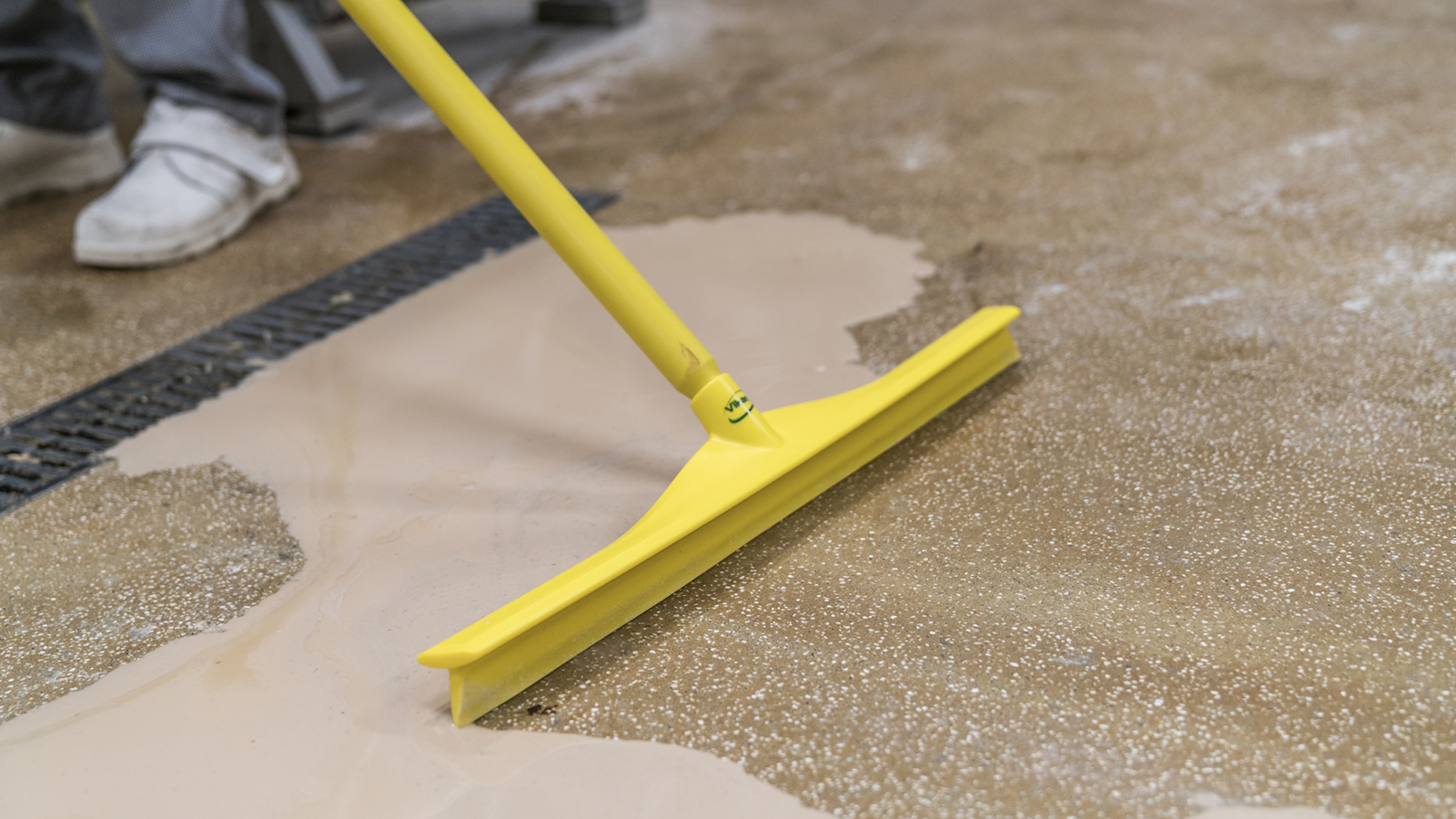 Yellow floor squeegee with a yellow handle