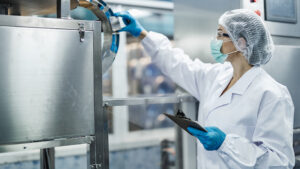 Employee carrying out a quality control check on a production installation