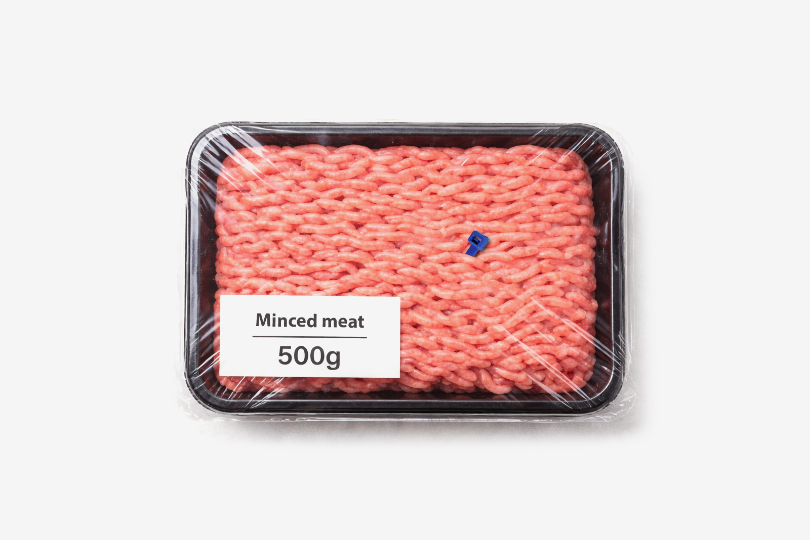 Pack of 500g minced beef in a plastic tray with a small blue plastic fragment inside