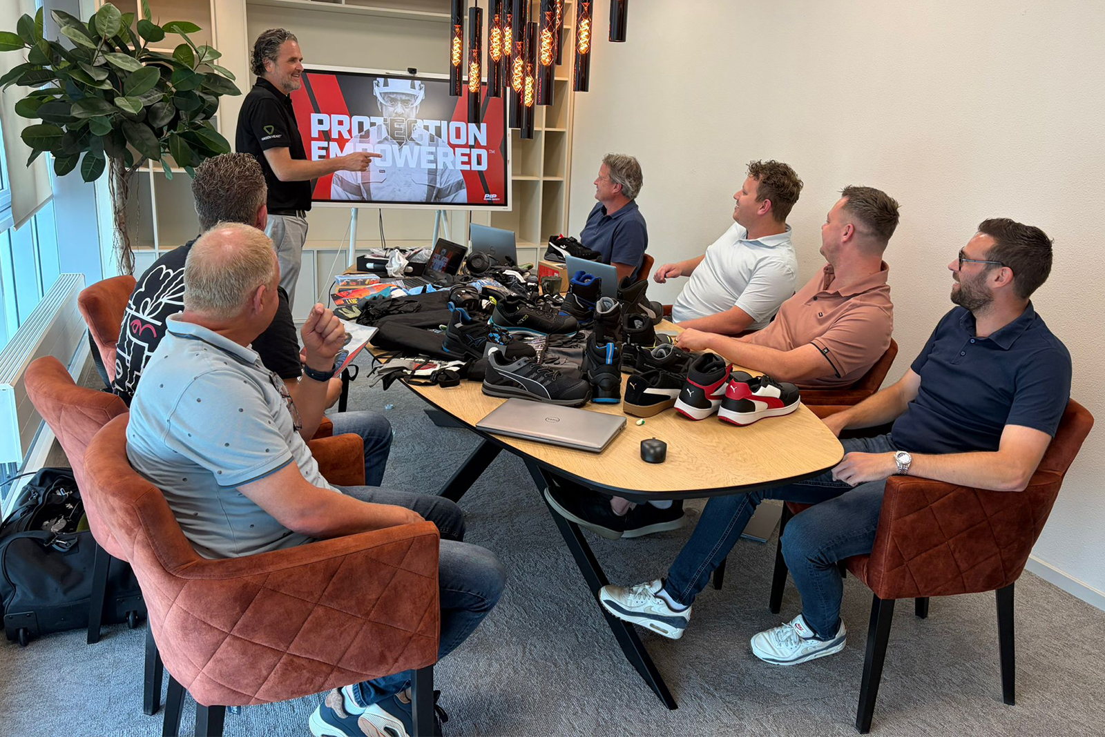 PPE presentation to a group of attendees in a meeting room.